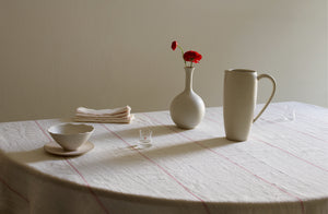 White Christiane Perrochon and Ted Muehling by Lobmeyr shot glass on red embroidered stripe white linen tablecloth with red renunculus.