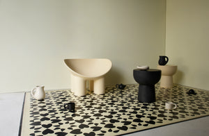 Cream and black faye toogood roly poly furniture and tabletop set on a handpainted floor with a simple shaker cream and black pattern