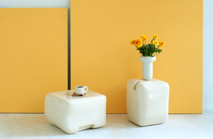 faye-toogood-cream-cobble-furniture-and-mug-and-vase-against-marigold-background
