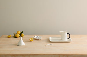 Kitchen butcher block with Feldspar Studio cobalt rimmed kitchen accessories and lemons.