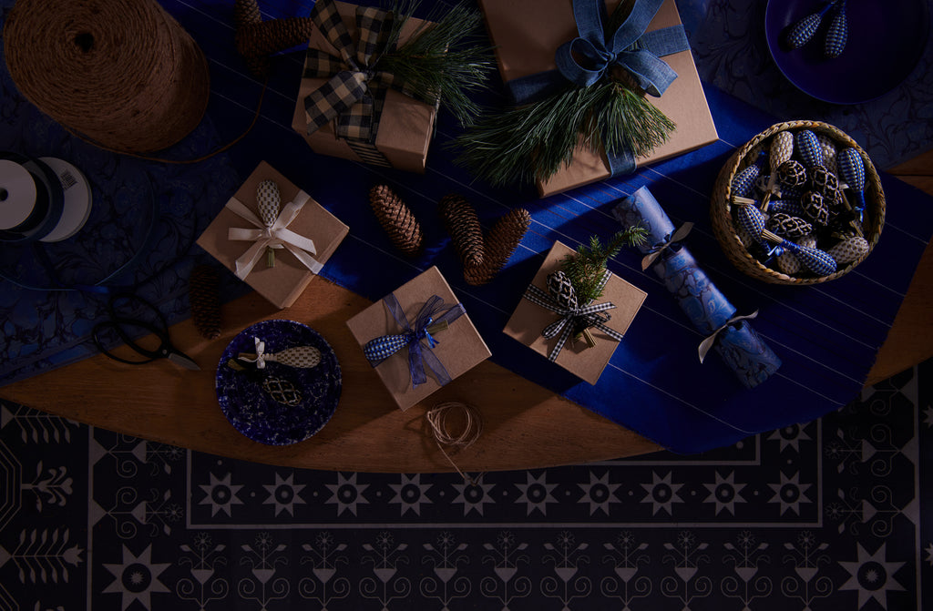 Lavender wand topped gift boxes with MARCH celebration crackers on Chroma cobalt stripe runner