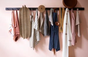 march steel peg rack hung with linens including kitchen towels