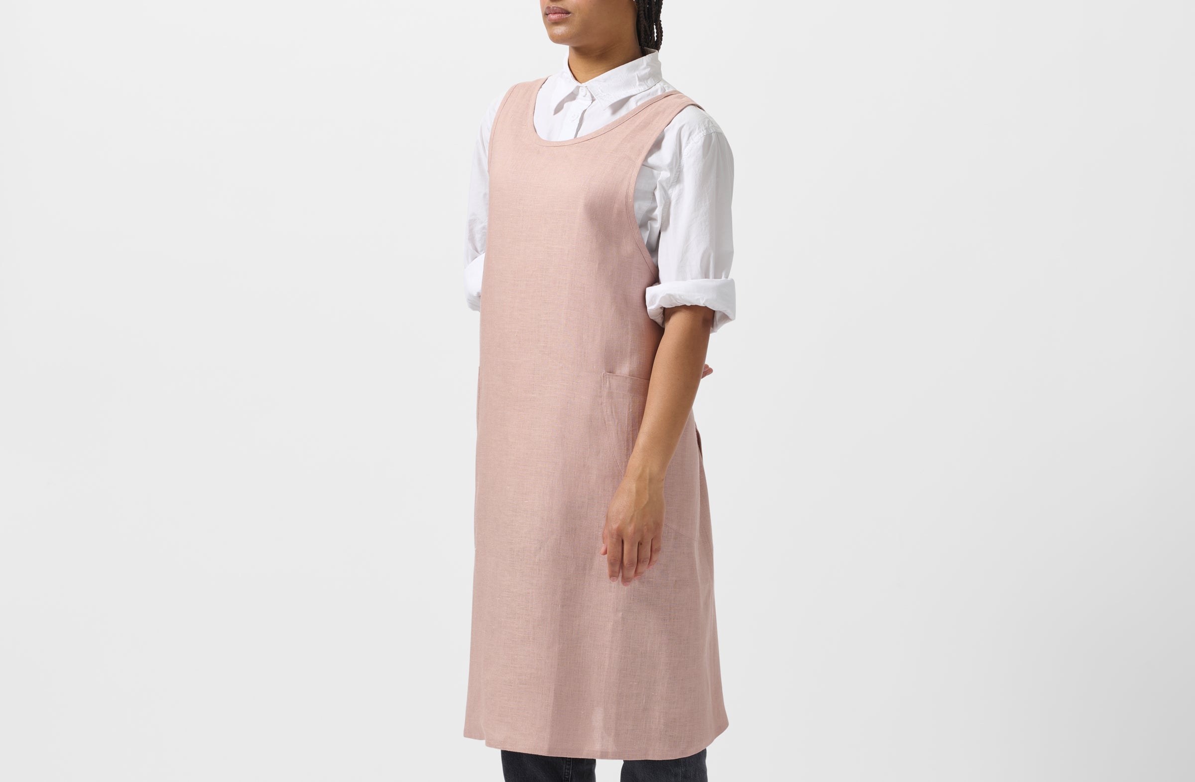 Model wearing MARCH At Work dusty pink linen cross back apron.