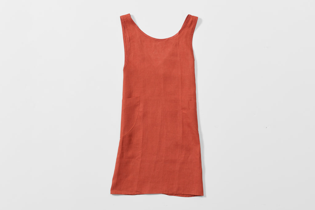 MARCH At Work rust linen cross back apron detail of front.