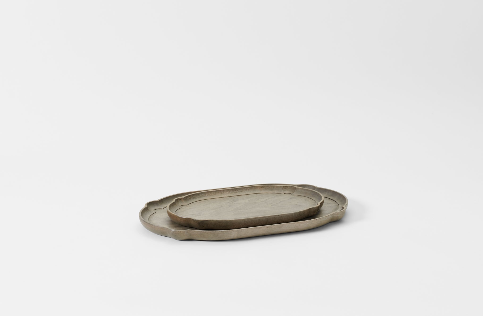 Two oval nested trays on a light gray background. Default