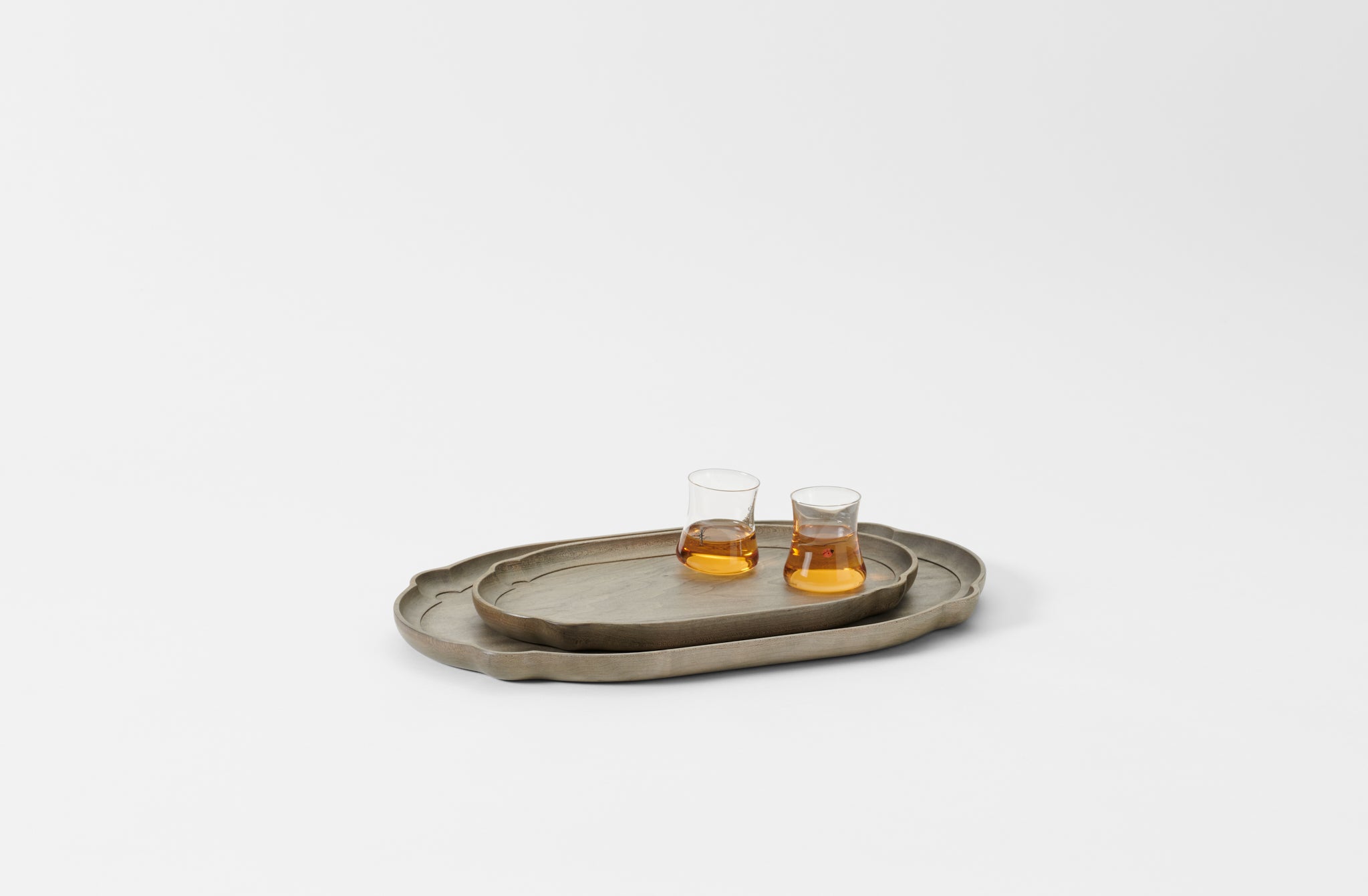 Two oval nested trays on a light gray background. Default