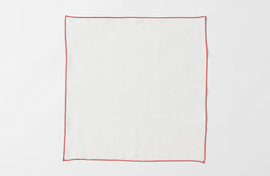 Detail of open red edge white linen napkins.