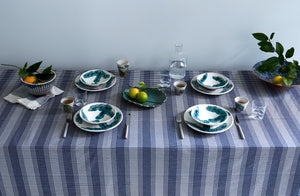 malaika-hand-painted-dinnerware-atop-tensira-navy-and-natural-plaid-tablecloth