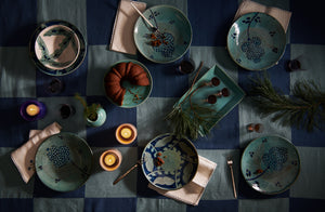 Malaika turquoise and blue dinnerware with Christiane Perrochonon on check tablecloth 