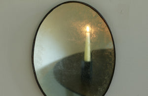 Maureen Fullam small oval gold mirror with reflected candle.