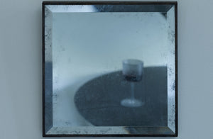 Maureen Fullam small square beveled antique mirror with wine glass on table reflected inside.