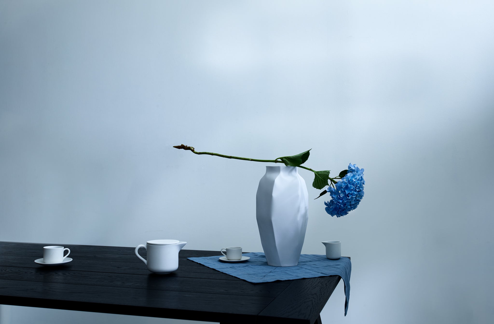 Peter speliopolous napkin under nymphenburg porcelain lightscape vase on table set with michael verheyden porcelain teapot and cups