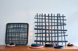 Dejonathan-kline-grid-sculpture-on-wall-behind-michael-verheyden-painted-wood-trays-and-bowl