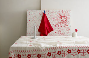 Michaël Verheyden for MARCH white mable paper towel holder and petite alabaster vase on folk red embroidered tablecloth.  