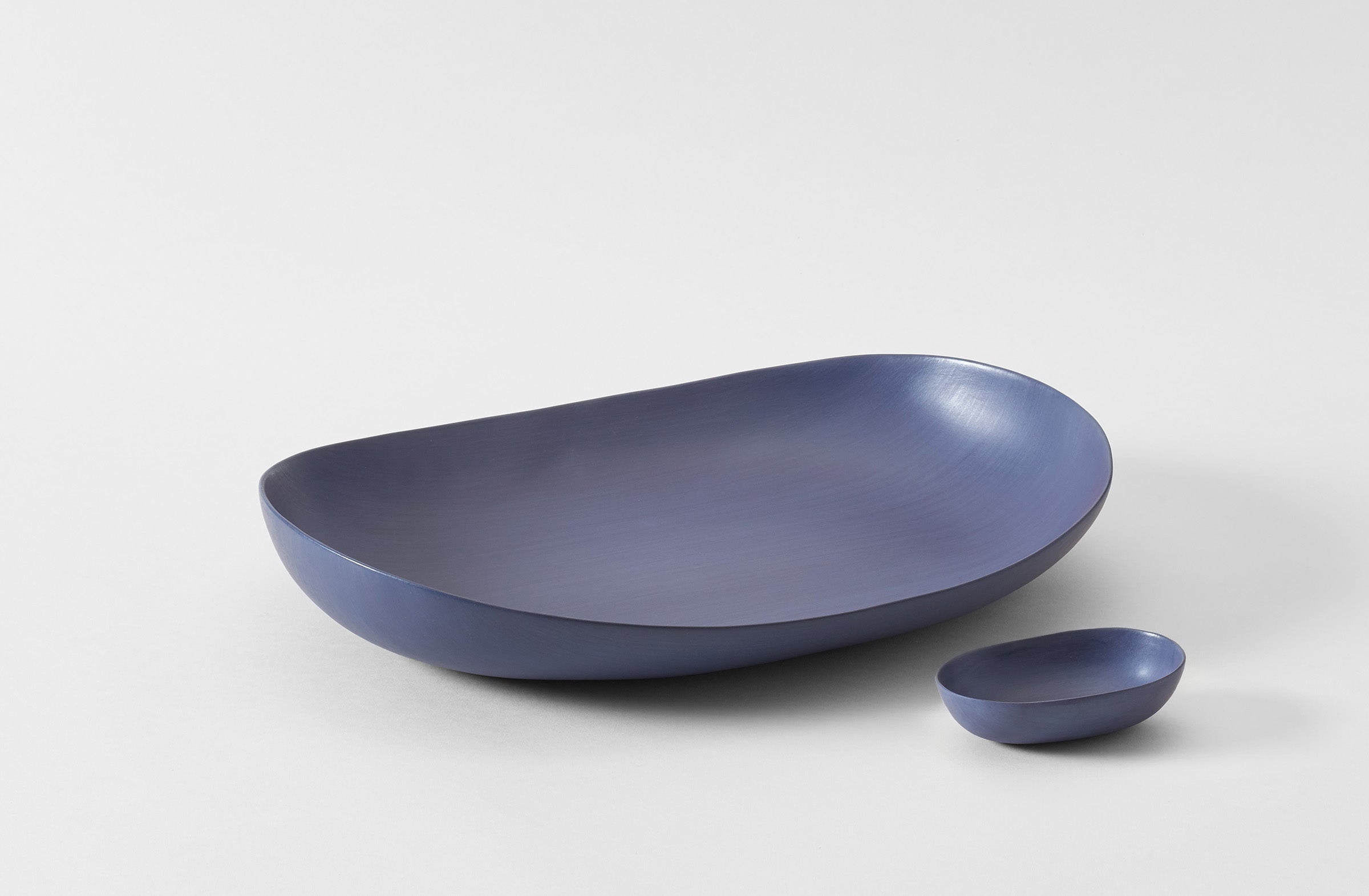 Two blue ceramic bowls on a light gray background. Default 