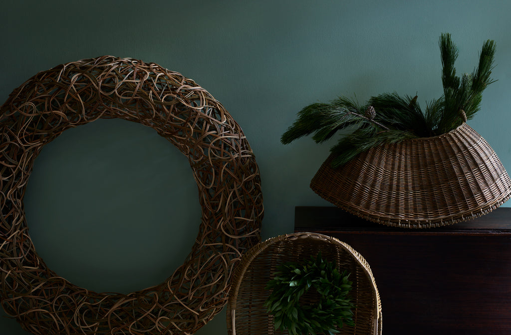 Studio Amos random woven wreath line scull and fish kettle baskets with holiday greenery.