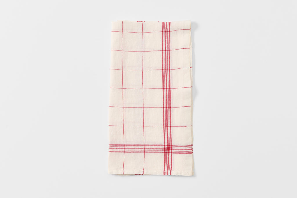 Red and white bistrot kitchen towel folded.