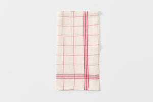 Red and white bistrot kitchen towel folded.