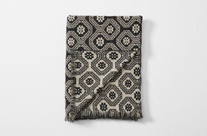Black and grey cerpa blanket folded with detail of reverse