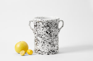 Black and white splatterware tall pot with lemons and a pomelo.