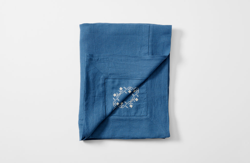 Embroidered blue ottoman vase tablecloth folded with embroidery detail