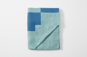 Blue and teal patchwork tablecloth folded