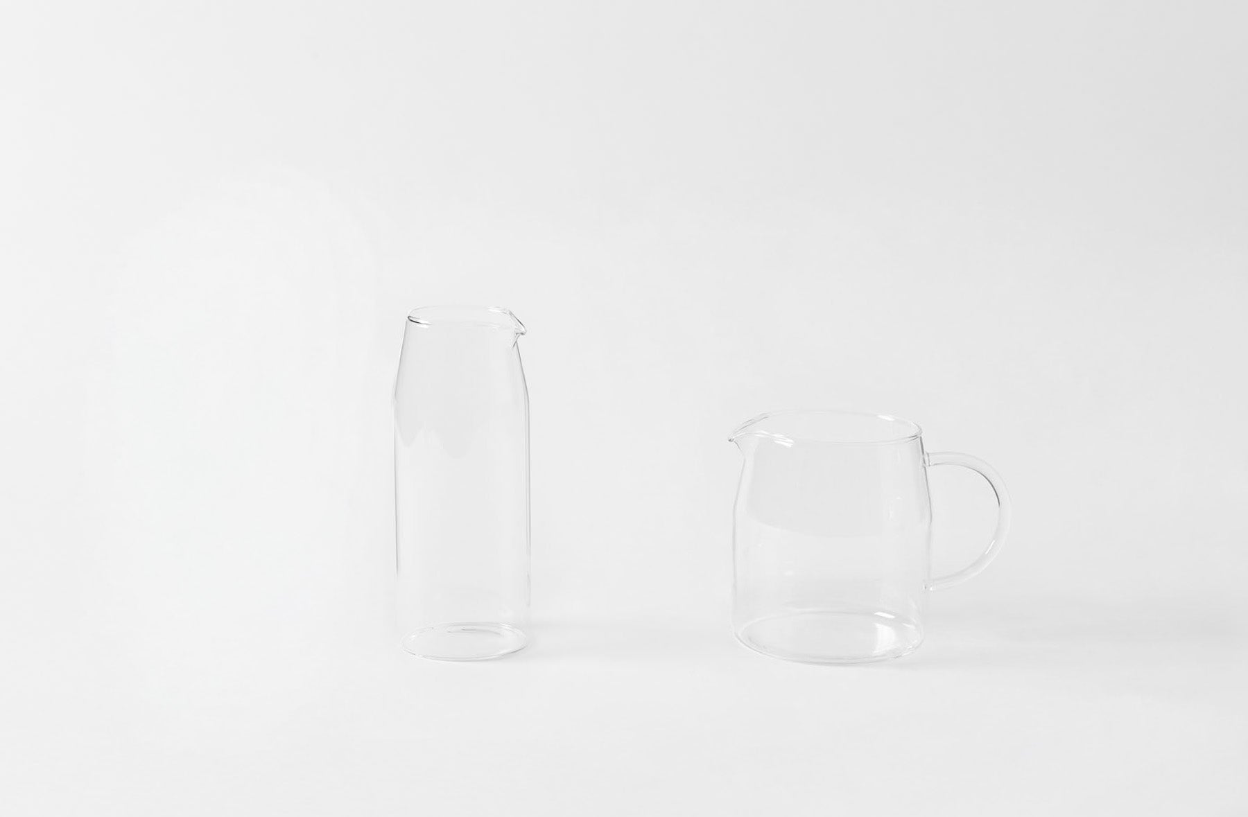 Clear glass pitcher and carafe on a white background. Default 