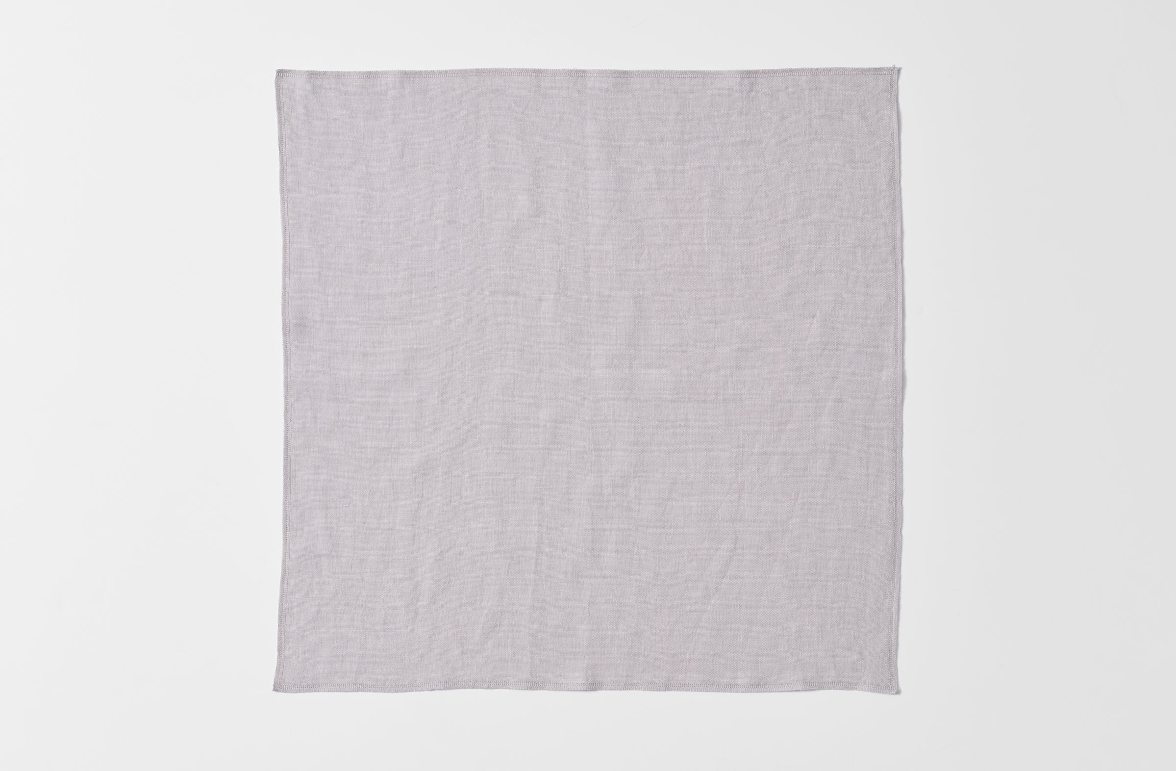 Detail of open boxwood silver linen overlock napkin.