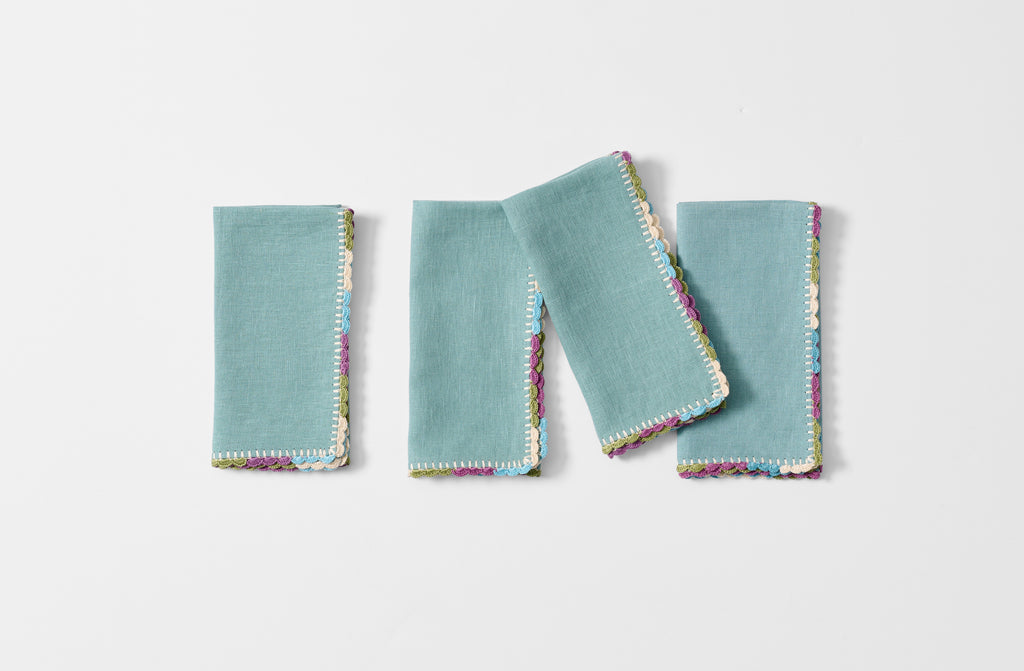 four folded Cairo linen napkins with crocheted hem.