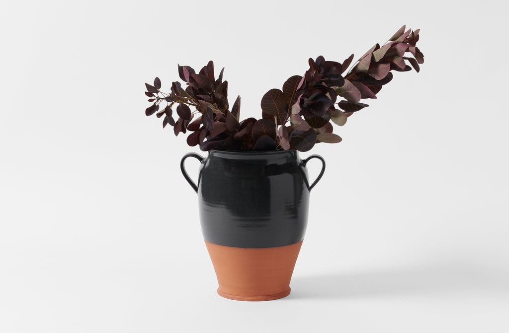 Charcoal stoneware large confit jar holding arrangement of leaves