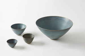 Set of Christiane Perrochon blue ceramic bowls on a white background. Default