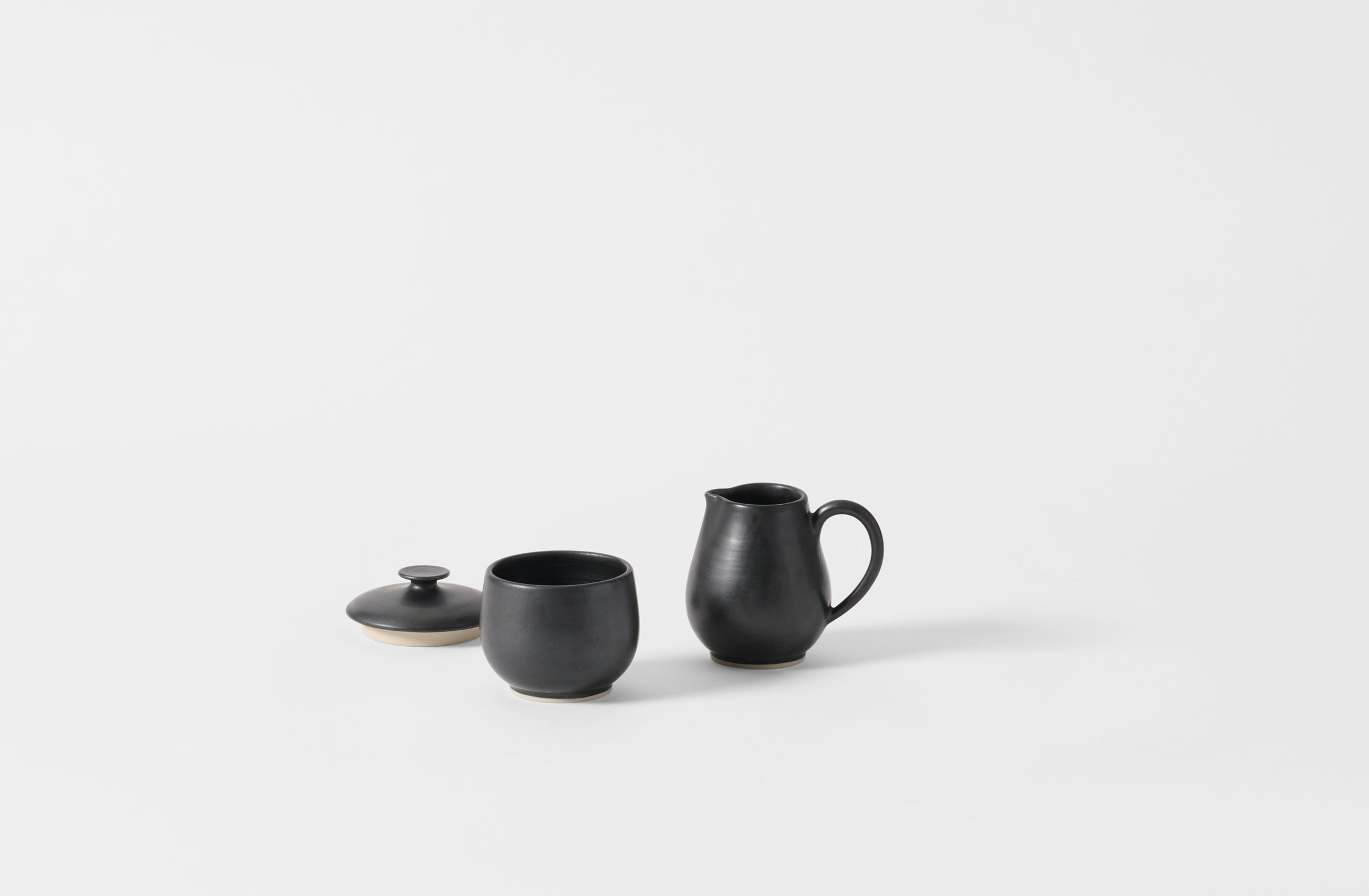 Black Christiane Perrochon lidded sugar bowl and creamer.