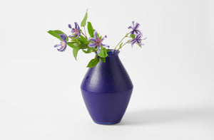 Christiane Perrochon blue violet vase holding purple flowers