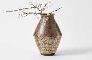 Christiane Perrochon dark brown spot large vase holding quince blossoms.