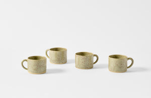 Four Christiane Perrochon green gray spot mugs.