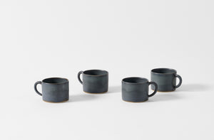 Four Christiane Perrochon grey blue mugs.