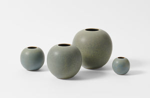 Group of four Christiane Perrochon grey blue round vases.