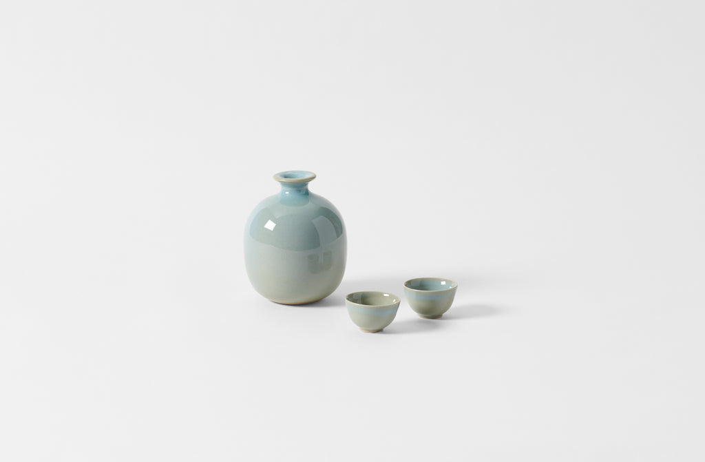 Christiane Perrochon iron blue sake bottle with two sake cups.
