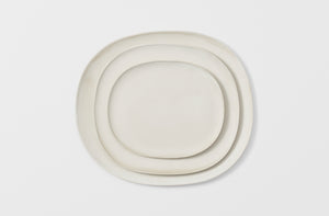 Christiane Perrochon nested powder white dinnerware overhead. Default