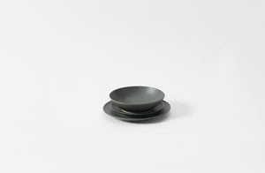 Set of slate Chirstiane Perrochon ceramic dinnerware on a white background. Default 