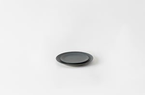 Two slate Christiane Perrochon ceramic plates on a white background. Default