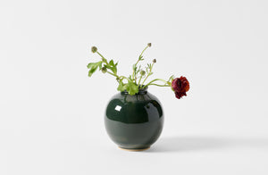 Christiane Perrochon small spruce boule vase with a delicate arrangement of ranunculus. 