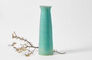 Christiane Perrochon turquoise extra large column vase with white plum blossom branch.