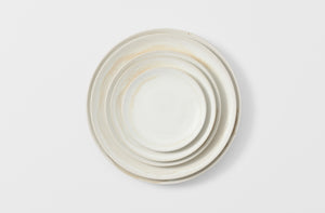 Christiane Perrochon nested powder white dinnerware overhead. Default