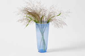 Davide Fuin blue cylinder vase holding grasses