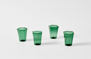 Four Davide Fuin dark green hexagon glasses.