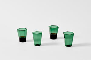 Four Davide Fuin dark green hexagon glasses.