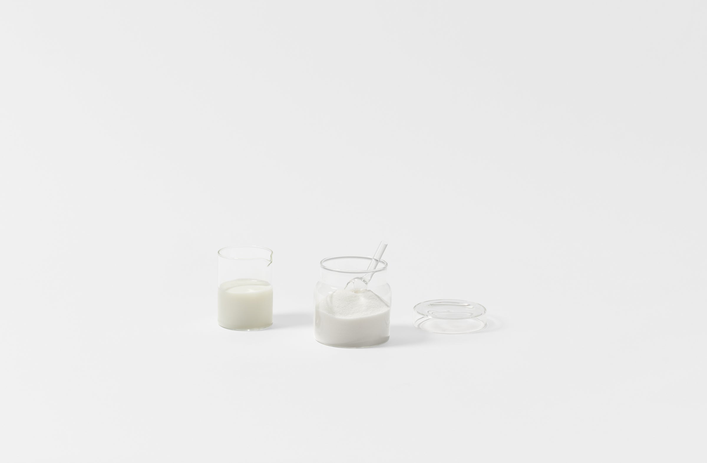 Glass creamer with glass sugar pot and scoop