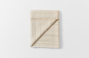 Greta natural stripe tablecloth folded with detail of reverse