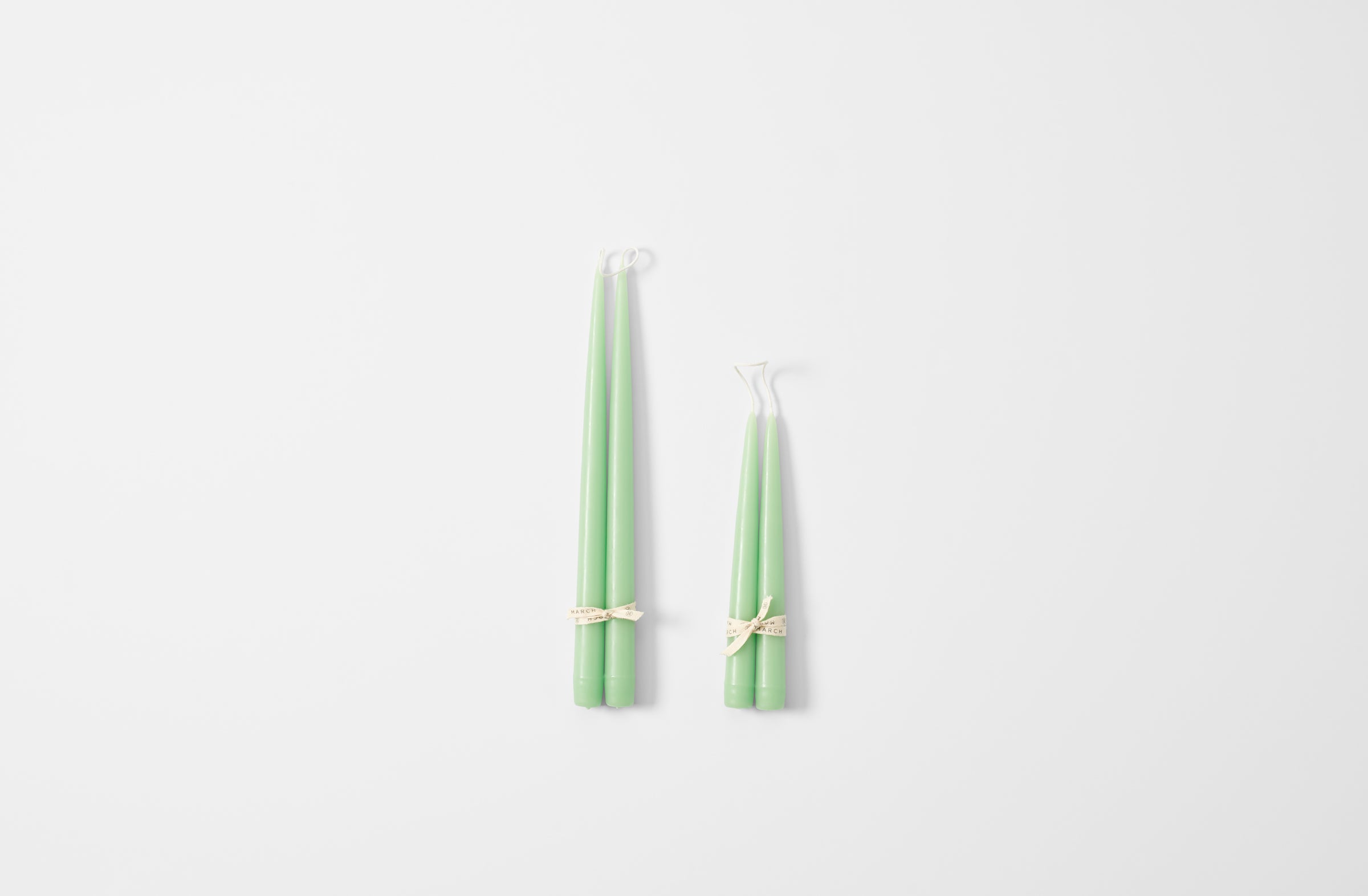 Hand dipped apple green taper candles.